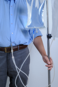 Peritoneal Dialysis user with catheter and saline bag